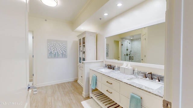 bathroom featuring vanity, crown molding, walk in shower, and hardwood / wood-style floors