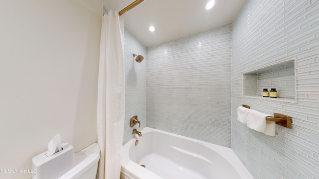 bathroom with toilet and shower / tub combo with curtain