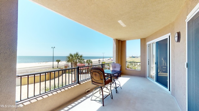 balcony with a view of the beach and a water view