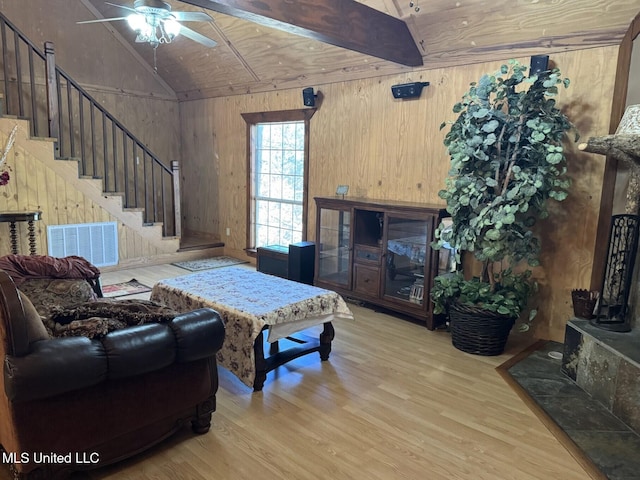 46 Stirling Rd, Natchez, MS 39120 - living room with wood walls, vaulted ceiling with beams, ceiling fan, light wood-type flooring, and wood ceiling