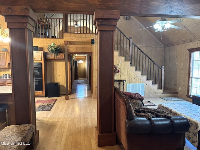 46 Stirling Rd, Natchez, MS 39120 - living room with hardwood / wood-style floors, high vaulted ceiling, ceiling fan, and wooden walls