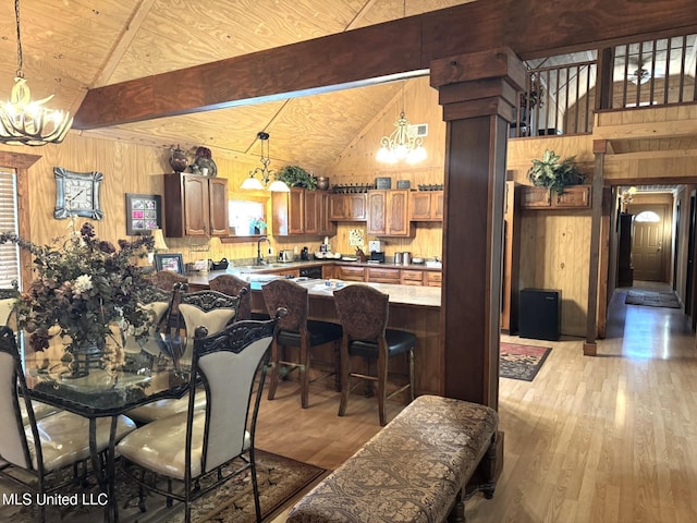 46 Stirling Rd, Natchez, MS 39120 - dining room with beamed ceiling, light hardwood / wood-style flooring, and wooden walls