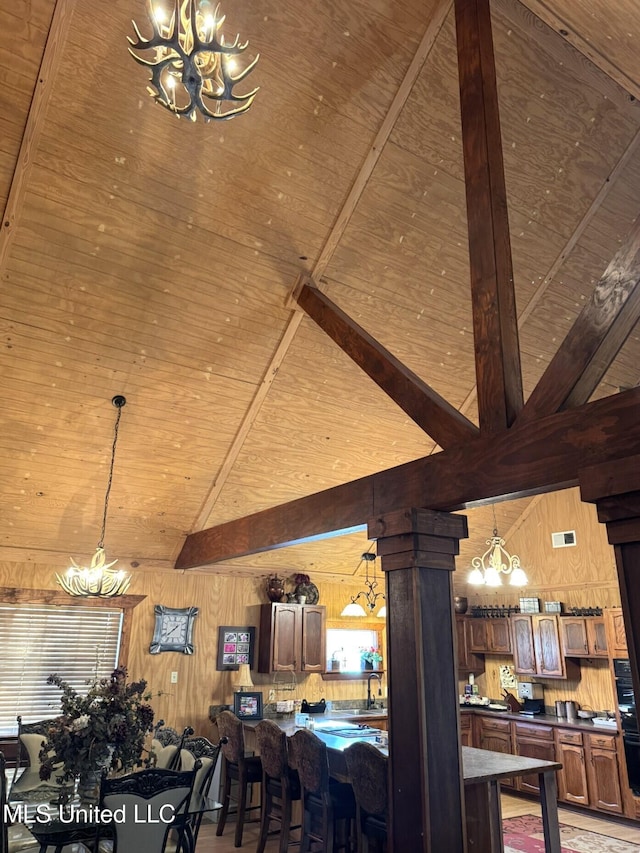 46 Stirling Rd, Natchez, MS 39120 - dining area with ornate columns, wooden ceiling, beamed ceiling, high vaulted ceiling, and wood walls