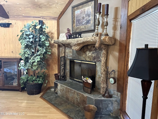 46 Stirling Rd, Natchez, MS 39120 - living room featuring wood-type flooring, a premium fireplace, wooden walls, and vaulted ceiling