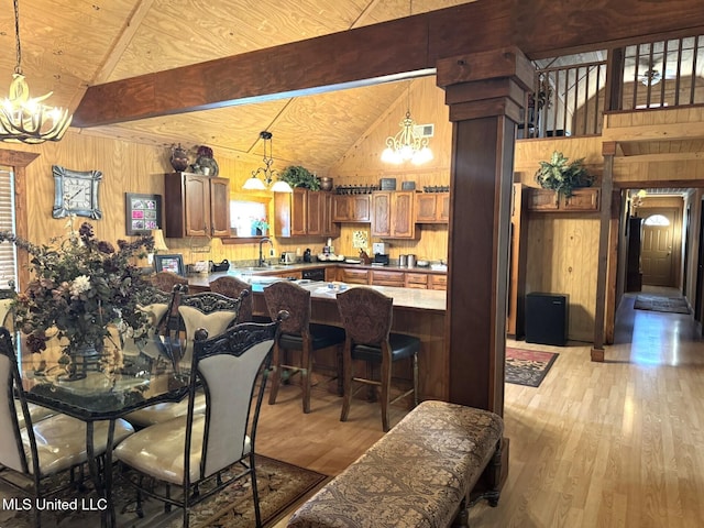 46 Stirling Rd, Natchez, MS 39120 - dining space with beamed ceiling, light hardwood / wood-style floors, and wooden walls