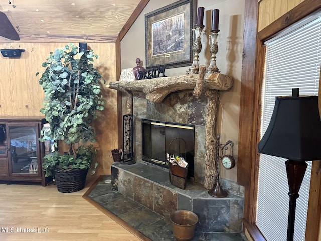 46 Stirling Rd, Natchez, MS 39120 - living room featuring a tile fireplace, wooden ceiling, wood walls, vaulted ceiling, and hardwood / wood-style flooring