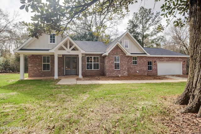 craftsman-style home with a garage, a front yard, and french doors