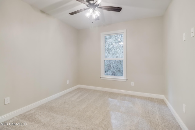 carpeted spare room with ceiling fan