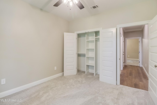 unfurnished bedroom with carpet floors, a closet, and ceiling fan