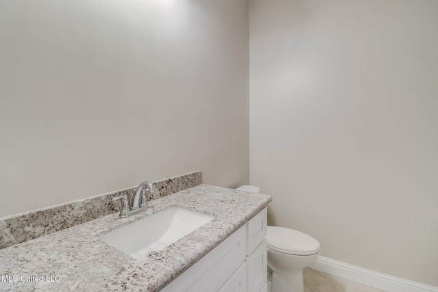 bathroom with tile patterned floors, vanity, and toilet