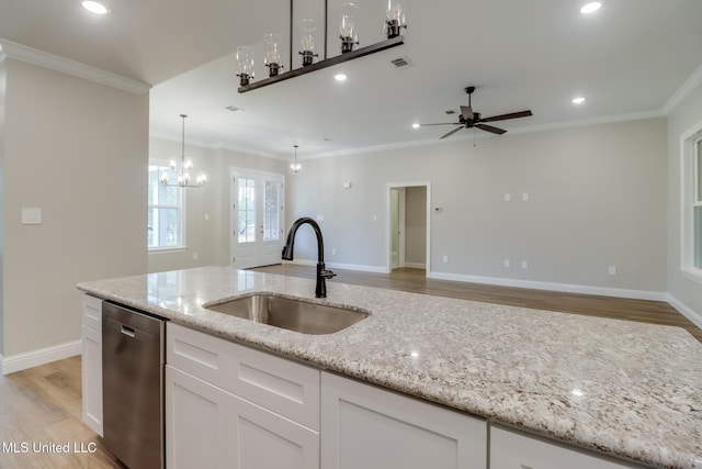 kitchen featuring white cabinetry, dishwasher, light stone countertops, and sink