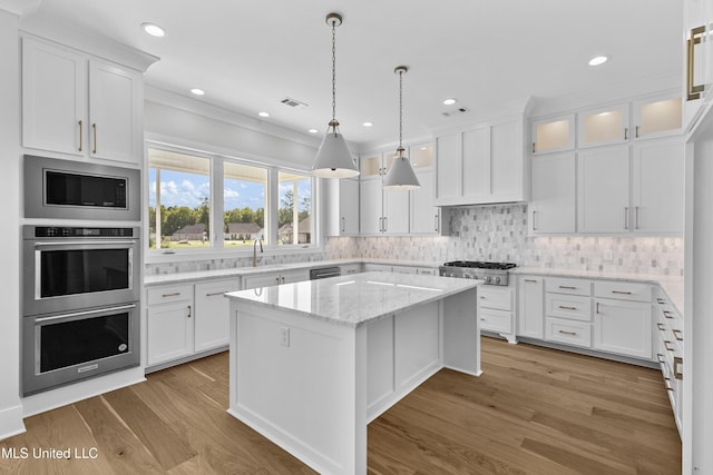 126 Herons Bay Cir Lot 1136, Madison, MS 39110 - kitchen featuring stainless steel appliances, visible vents, a kitchen island, and white cabinetry