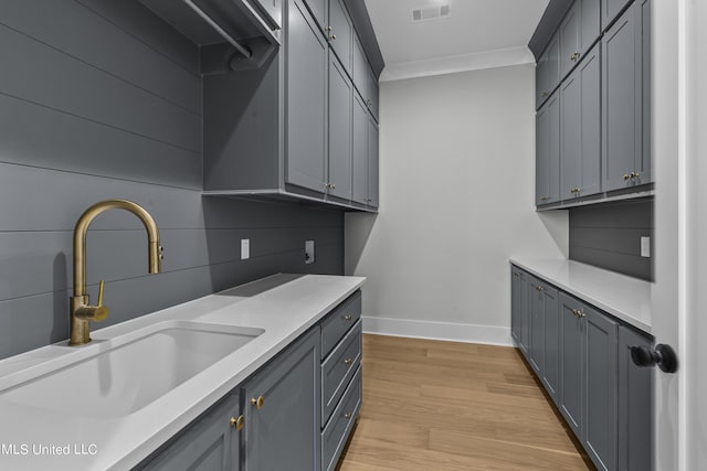 126 Herons Bay Cir Lot 1136, Madison, MS 39110 - washroom featuring a sink, light wood-style floors, baseboards, ornamental molding, and visible vents