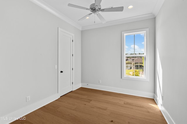 spare room featuring ceiling fan, wood-type flooring, and ornamental molding