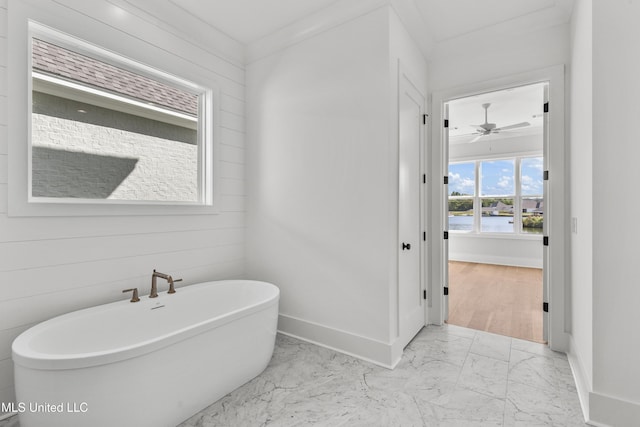 126 Herons Bay Cir Lot 1136, Madison, MS 39110 - bathroom featuring marble finish floor, a water view, baseboards, a soaking tub, and ceiling fan
