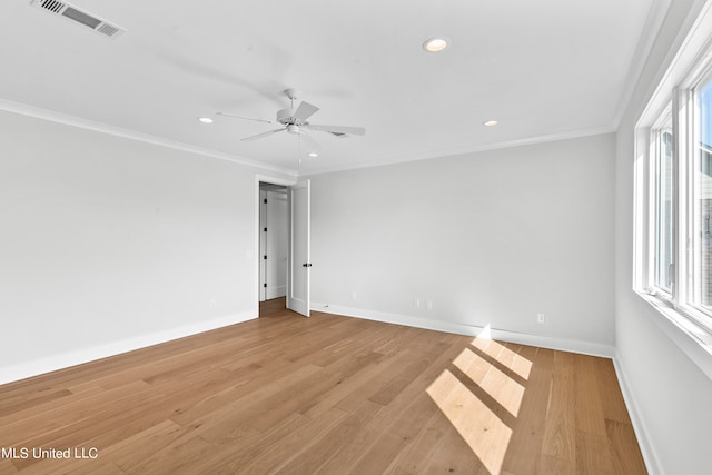 spare room featuring light hardwood / wood-style flooring, ceiling fan, and crown molding