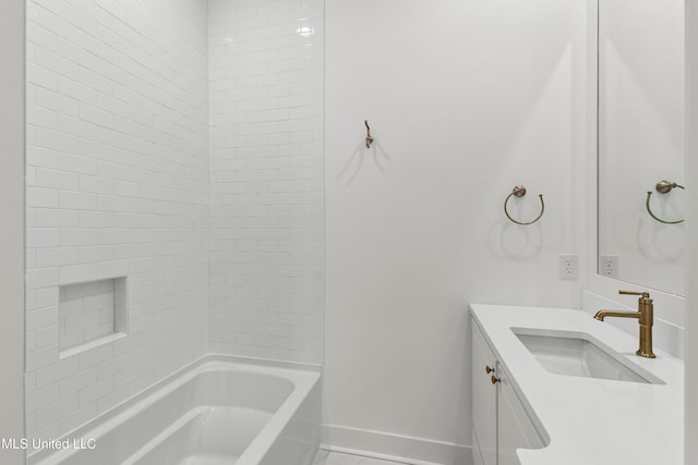 bathroom featuring vanity and tiled shower / bath combo