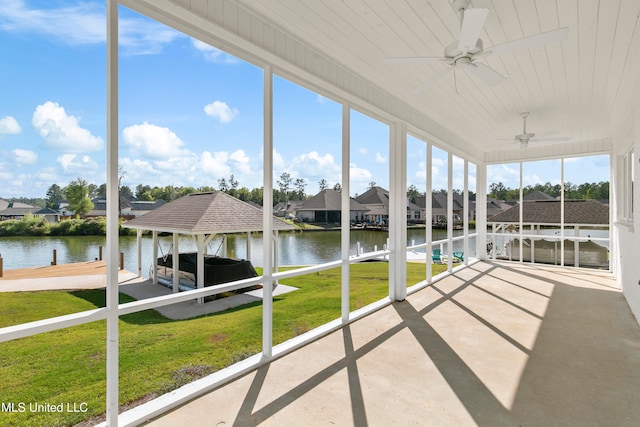 unfurnished sunroom with wooden ceiling, a water view, and ceiling fan