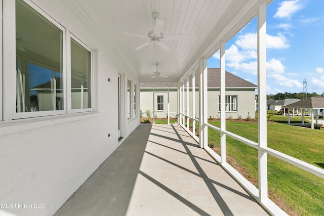 unfurnished sunroom with ceiling fan and a healthy amount of sunlight