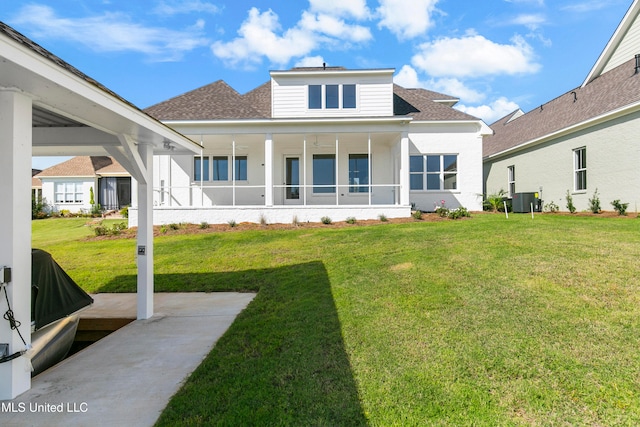 back of house with a lawn and central AC unit