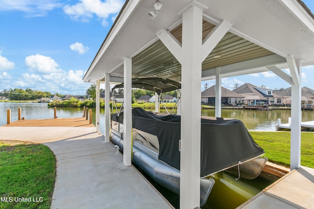 view of dock with a water view and a lawn