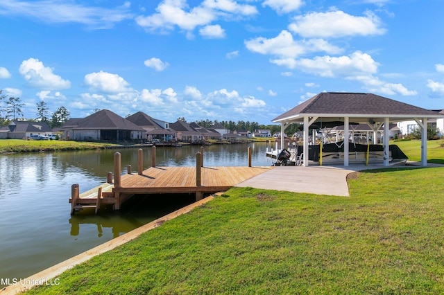 view of dock with a lawn and a water view