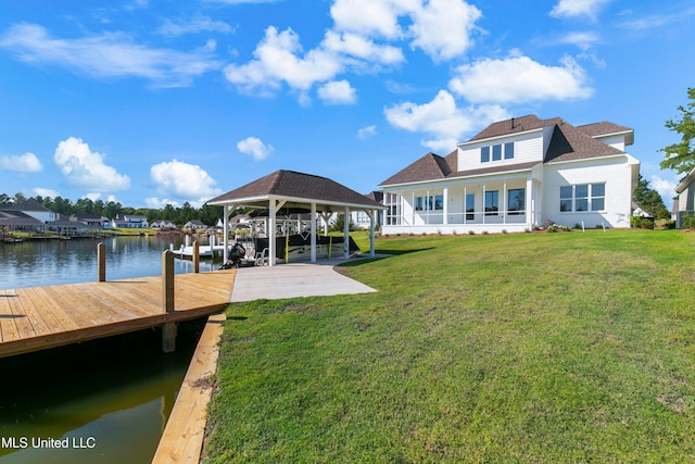 view of dock with a water view and a yard