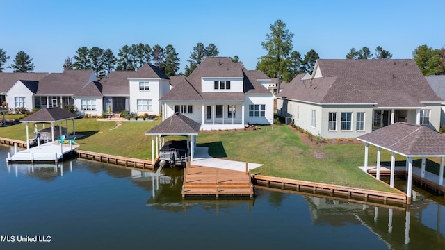 dock area featuring a water view and a lawn