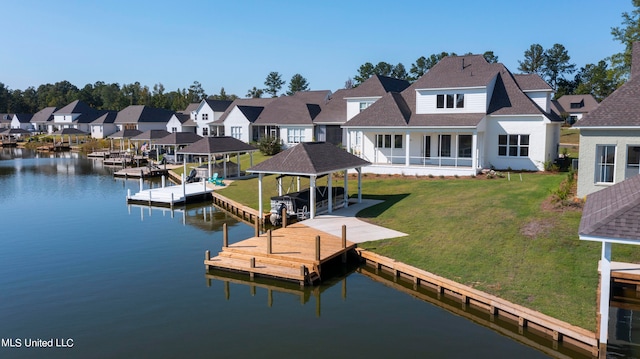 view of dock featuring a water view and a yard