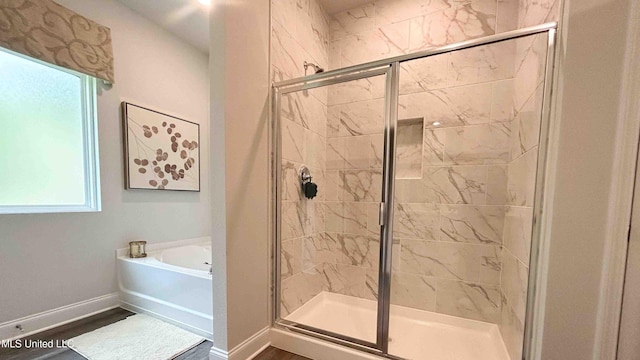 bathroom featuring separate shower and tub