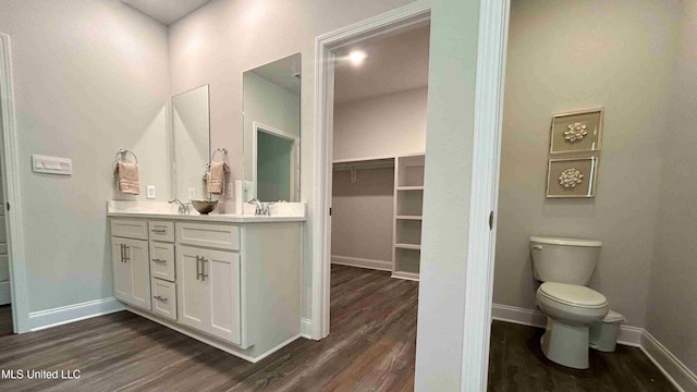 bathroom with vanity, hardwood / wood-style floors, and toilet