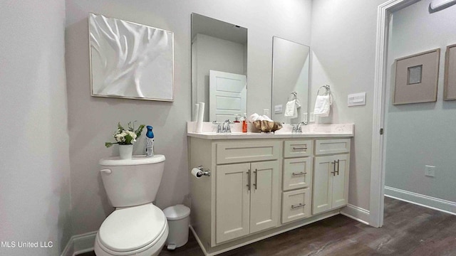 bathroom with vanity, wood-type flooring, and toilet