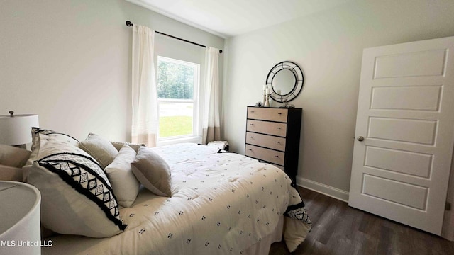 bedroom featuring dark wood-type flooring