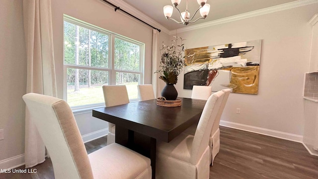 dining area featuring ornamental molding, dark hardwood / wood-style floors, and an inviting chandelier