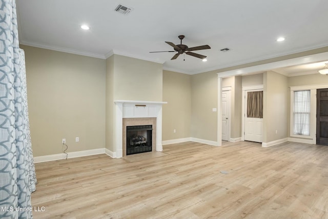 unfurnished living room with light wood finished floors, visible vents, and a tile fireplace