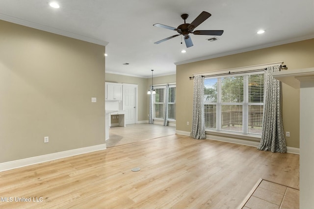 unfurnished room with ceiling fan, ornamental molding, visible vents, and light wood-style floors