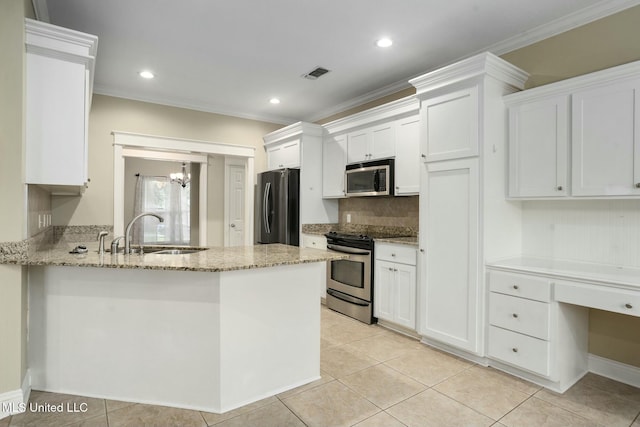 kitchen featuring visible vents, white cabinets, ornamental molding, stainless steel appliances, and a sink