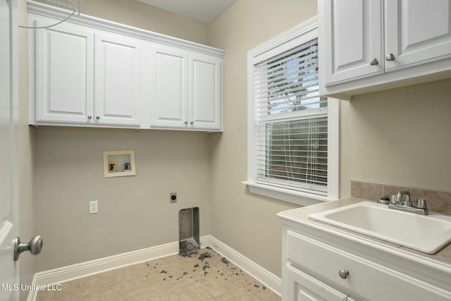 laundry room featuring cabinet space, baseboards, hookup for a washing machine, electric dryer hookup, and a sink