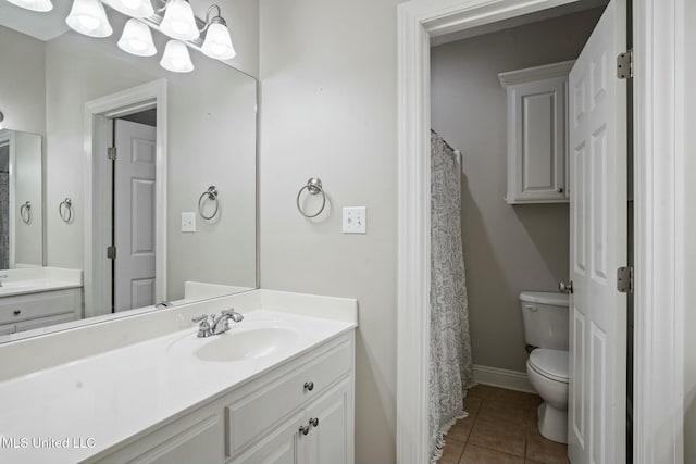 full bathroom featuring vanity, tile patterned flooring, toilet, and baseboards