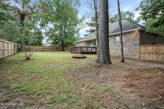 view of yard featuring a fenced backyard and a deck