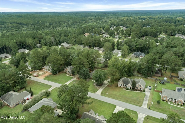 birds eye view of property featuring a view of trees