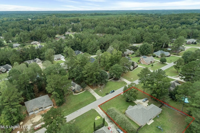 birds eye view of property featuring a view of trees