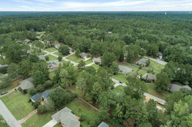 bird's eye view with a wooded view and a residential view