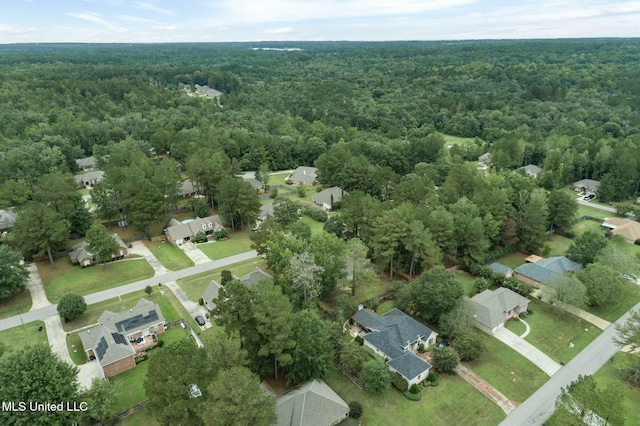 drone / aerial view featuring a residential view and a view of trees