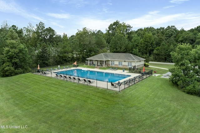 pool featuring a patio, a lawn, and fence