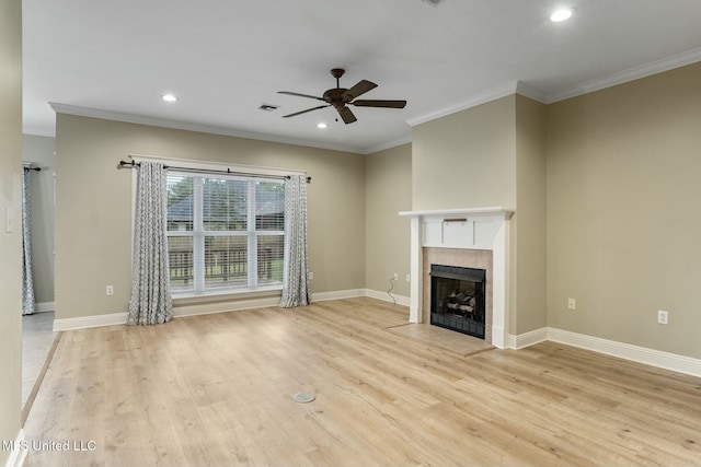 unfurnished living room featuring crown molding, a fireplace, baseboards, and wood finished floors