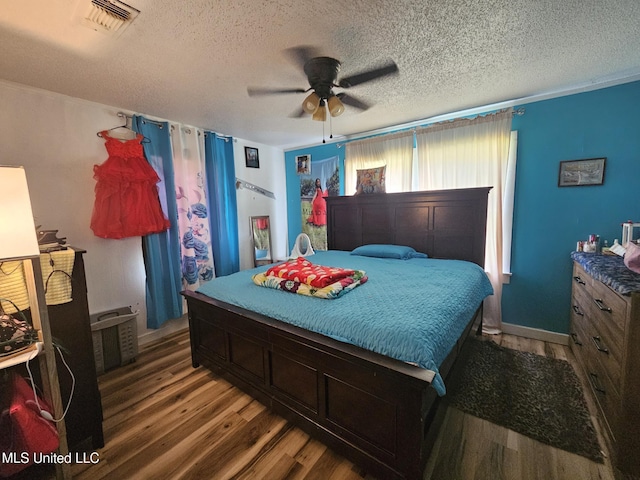 2305 Roberts Ave, Gulfport, MS 39501 - bedroom with wood finished floors, a textured ceiling, and a ceiling fan
