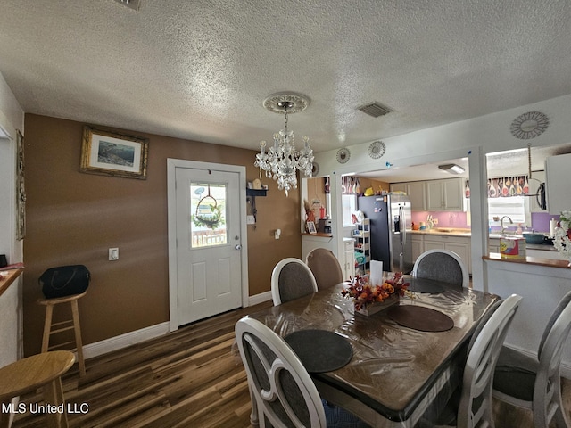 2305 Roberts Ave, Gulfport, MS 39501 - dining space featuring a chandelier, dark wood-style floors, and a textured ceiling