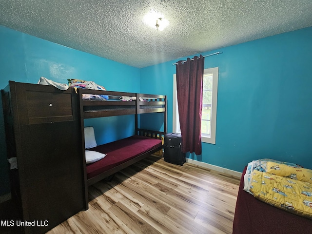 2305 Roberts Ave, Gulfport, MS 39501 - bedroom featuring wood finished floors and a textured ceiling