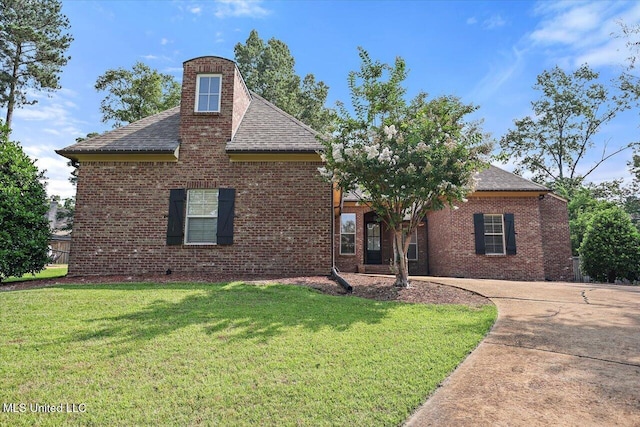 306 Canebreak Cv, Madison, MS 39110 - view of front of house with brick siding, a front yard, a shingled roof, and a chimney